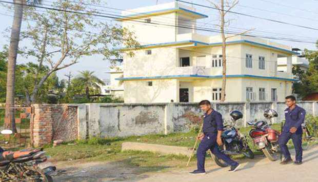Police walk past the local election commission office in Janakpur, some 300km south of Kathmandu, yesterday.