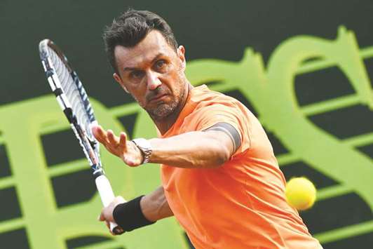 Paolo Maldini returns the ball during the menu2019s doubles match, with his partner Stefano Landonio, against Polandu2019s Tomasz Bednarek and Netherlandu2019s David Pel in the ATP Challenger Tour tournament in Milan on Tuesday. (AFP)