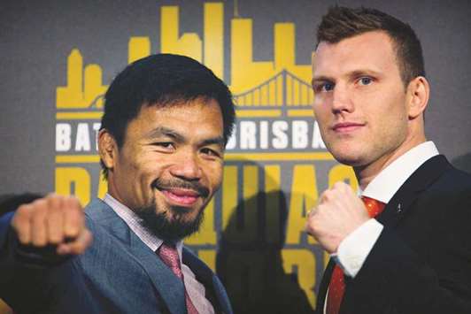 Philippine boxer Manny Pacquiao (L) and Australian challenger Jeff Horn pose after a press conference to promote their fight.