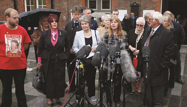 Family members of victims of the 1989 Hillsborough stadium disaster speak to the press outside Parr Hall, where the Crown Prosecution Service announced its Hillsborough disaster charging decision, in Warrington yesterday.