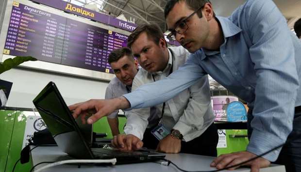 Technicians work on a flight timetable for the airport's site at the capital's main airport, Boryspil, outside Kiev