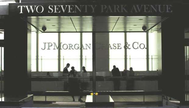 People walk inside JPMorgan headquarters in New York. JPMorgan, Citigroup and Bank of America led US firms in unveiling plans to boost dividends and stock buybacks more than analysts had projected, after every lender passed annual stress tests for the first time since the Fed began the reviews in the wake of the 2008 financial crisis.