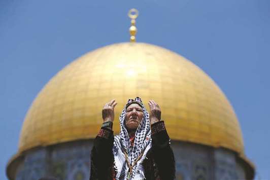 A Palestinian woman prays on the first Friday of the holy fasting month of Ramadan, in Jerusalemu2019s Old City, yesterday.