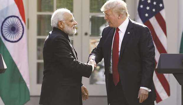 US President Donald Trump (right) greets Indian Prime Minister Narendra Modi during their joint news conference in Washington (file). Indiau2019s Gas Authority of India Limited has deals to buy 5.8mn tonnes of US LNG per annum for 20 years, mostly with Cheniere, but is now asking to re-negotiate the price.