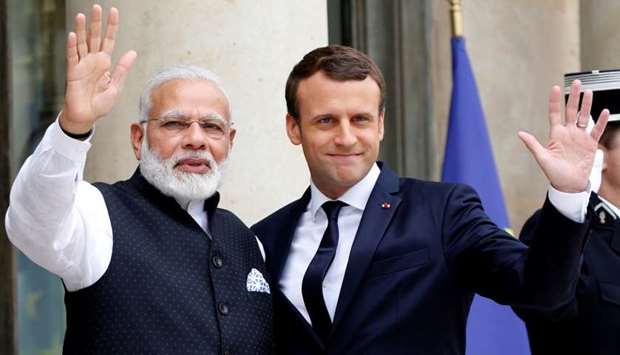 Indian Prime Minister Narendra Modi is greeted by French President Emmanuel Macron
