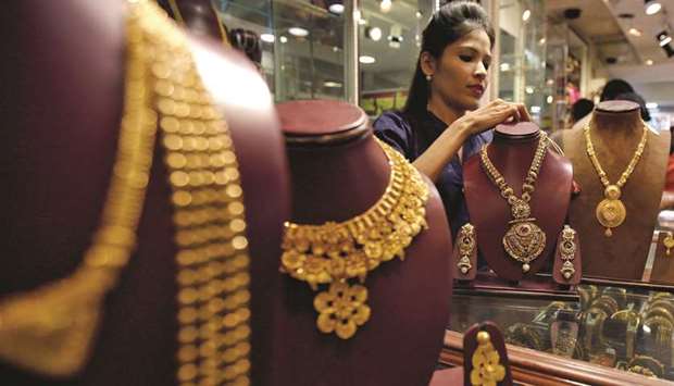 A salesperson is seen inside a jewellery showroom in Mumbai. Under the new nationwide sales tax that comes into effect in India on July 1, gold jewellery, silver and processed diamonds will be taxed at 3%, while the tax on rough diamonds will be 0.25%, a revenue official said yesterday.