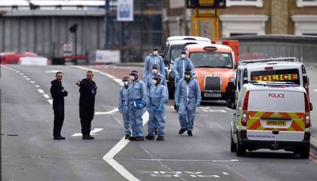 Police forensic investigators works on London Bridge after an attack left 7 people dead and dozens injured in London, Britain.
