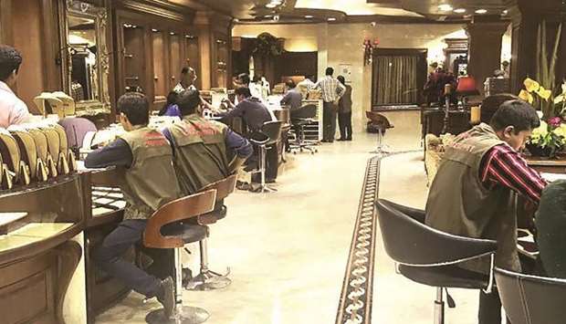 This handout photograph shows Bangladesh Customs Intelligence and Investigation Directorate (CIID) officials checking legal documents for gold being sold at an Apan Jewellers outlet in Dhaka.