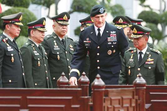 The chief commander of the US Army Pacific, General Robert B Brown, walks with his Thai counterpart, General Chalermchai Sittisart (right) at the Royal Thai Army headquarters in Bangkok yesterday.