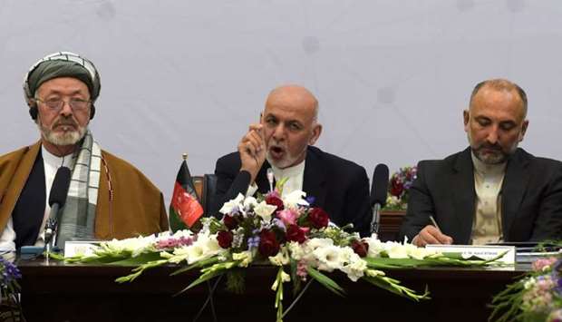 Afghan President Ashraf Ghani (C) delivers his speech at an international peace conference in Kabul