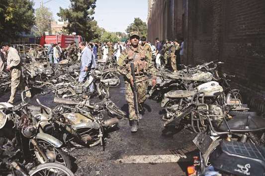 Afghan security personnel arrive at the site of a motorcycle bomb explosion in front of the Jami Mosque in Herat yesterday.