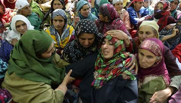 The mother (centre R) of Indian Kashimiri college student Adil Farooq Magray cries during Adil's funeral at Ganawpora village in Shopian district, south of Srinagar.