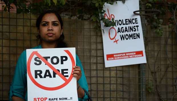 An Indian social activist holding a placard during a protest against a rape at Hauz Khas village in New Delhi. February 21, 2017 file picture.