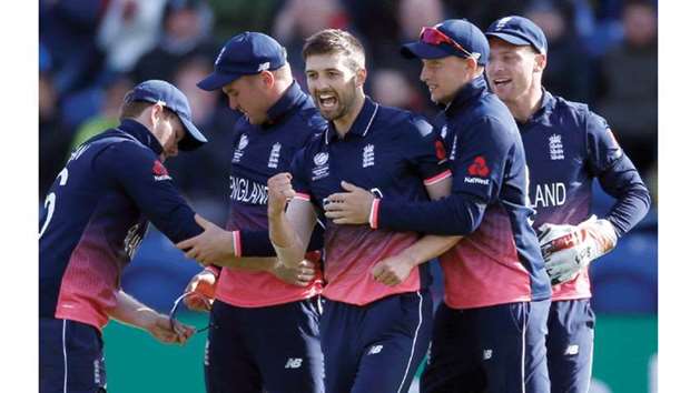 England's Mark Wood (centre) took the key wicket of New Zealand captain Kane Williamson, which sparked a collapse that saw Kiwis lose their last eight wickets for 65 runs. (Reuters)