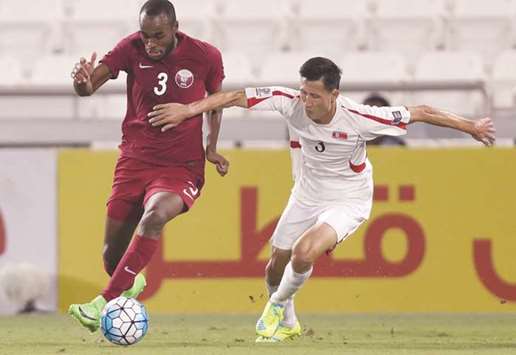 Qataru2019s Abdul Kareem Hassan (left) in action against North Korea during a friendly in Doha on Tuesday.
