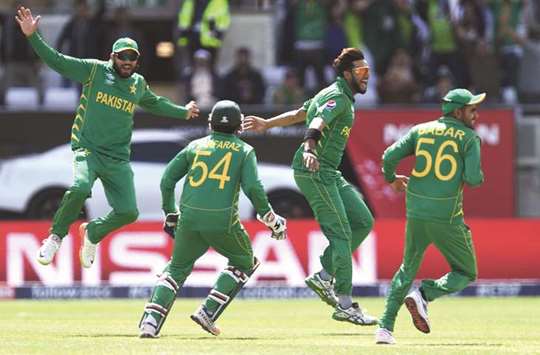 Pakistanu2019s spinner Imad Wasim (second right) celebrates with teammates after taking the wicket of South Africau2019s AB de Villiers during the ICC Champions trophy match in Birmingham. (AFP)