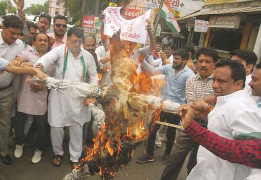 Demonstrators burn an effigy depicting Madhya Pradesh Chief Minister Shivraj Singh Chauhan during a protest organised by the Congress Party in Bhopal yesterday.