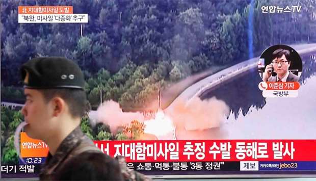 A TV broadcast of a news report on North Korea firing what appeared to be several land-to-ship missiles