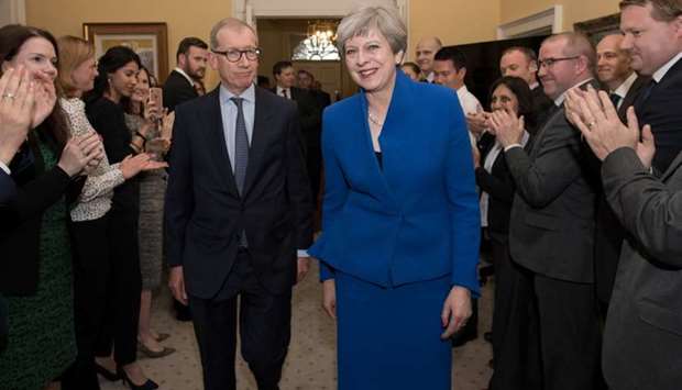 Britain's Prime Minister Theresa May and her husband Philip are welcomed by staff inside 10 Downing Street, in London, Britain.