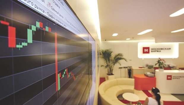 An electronic board displays stock price index curve at the Micex-RTS Moscow Exchange, Russiau2019s benchmark stock index, in Moscow. Fund managers including RAM Capital and Union Bancaire Privee are eyeing up an earnings yield of as much as 17.8% for Russiau2019s dollar-denominated RTS stock index, compared with just 3.5% for rouble bonds.