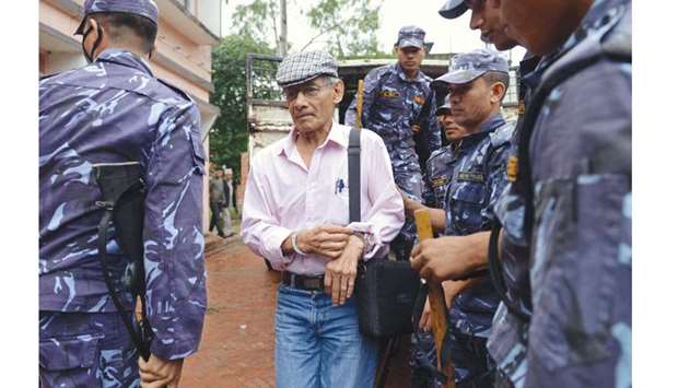 This file photo shows Charles Sobhraj, left, being brought to the district court for a hearing on a case related to the murder of Canadian backpacker Laurent Ormond Carriere, in Bhaktapur, near Kathmandu.