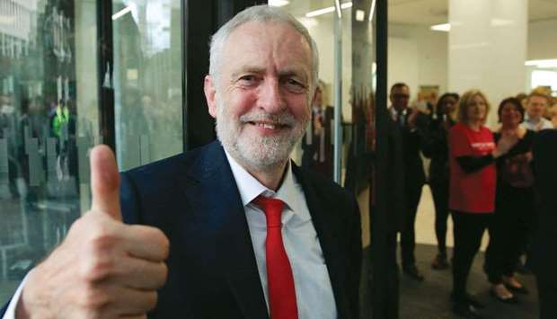 Labour party Leader Jeremy Corbyn gives a thumbs up as he arrives at Labour Party  headquarters in central London yesterday.
