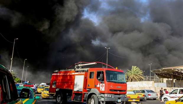 A fire truck arriving at the scene of a blaze at Iraq's biggest ballot warehouse, where votes for the eastern Baghdad district were stored, in the centre of the capital Baghdad.