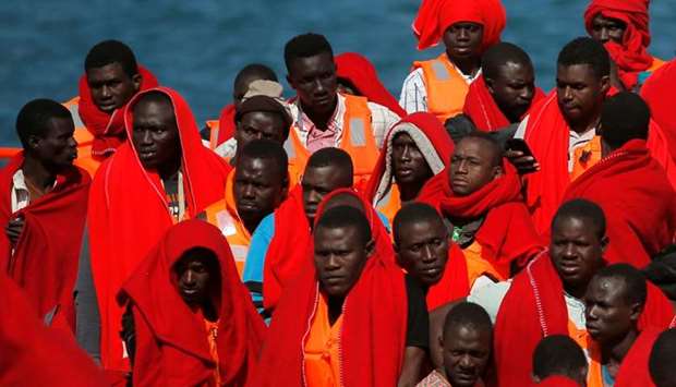 Migrants, part of a group intercepted aboard two dinghies off the coast in the Mediterranean Sea, stand on a rescue boat upon arrival at the port of Malaga, Spain. Reuters