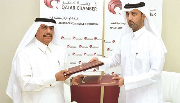 Qatar Chamber director generalu2019s assistant for Governmental and International Relations Ali bu Sherbak al-Mansouri and Hawkama Centre chairman Mansour Ahmed al-Saadi shake hands after signing the MoU.