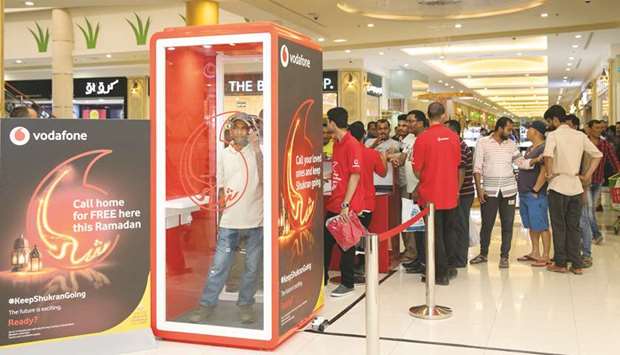 People queue up to make calls from Vodafone Shukran phone booth.