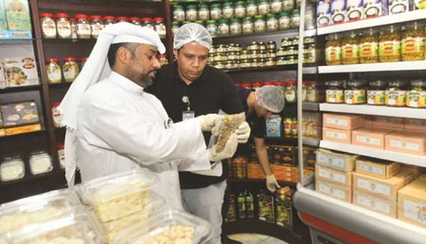 A municipality official conducting an inspcetion at a shop.