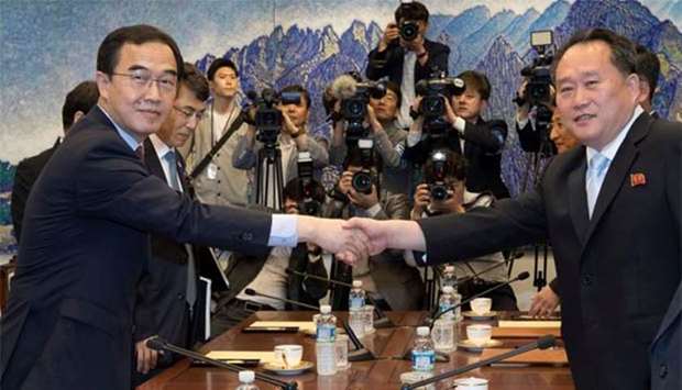 South Korean Unification Minister Cho Myoung-gyon shakes hands with his North Korean counterpart Ri Son Gwon during their meeting at the truce village of Panmunjom on Friday.