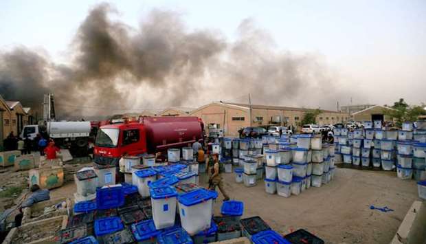 Ballot boxes are seen after a fire yesterday at a storage site in Baghdad, housing the boxes from Iraq's May parliamentary election.