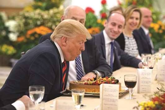 US President Donald Trump blows a candle after being presented a cake during a working lunch with Singaporeu2019s Prime Minister Lee Hsien Loong (not in picture) during his visit to The Istana, the official residence of the prime minister, in Singapore.