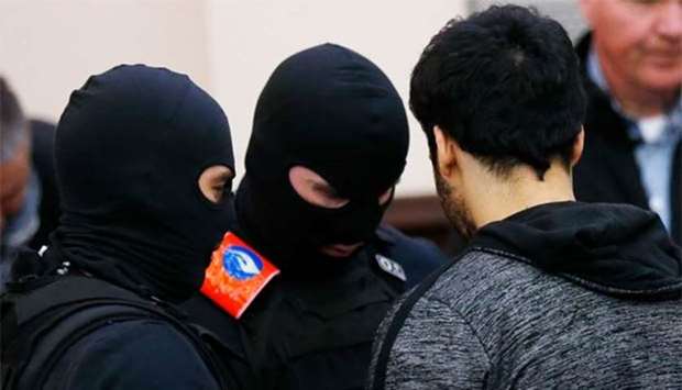 Sofiane Ayari (right) is escorted by Belgian police officers as he arrives in a courtroom in Brussels. File picture