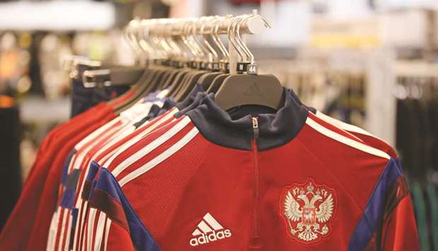 The coat of arms of the Russian Federation sits on a sports jersey inside the Adidas sportswear store in Moscow (file). Now Adidas in Russia is just a little more than half the size it was in the 2014 heyday, but generates more income from every pair of sneakers sold there than three years ago, when it first started to break out performance in the country.