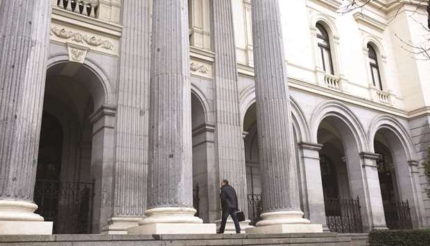 A visitor enters the Madrid Stock Exchange in Spain (file). The IBEX 35 closed up 1.6% to 9,898 points yesterday.