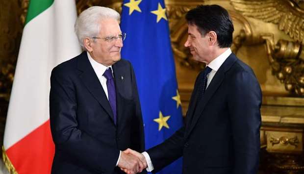 Italyu2019s Prime Minister Giuseppe Conte (R) shakes hands with Italy's President Sergio Mattarella during the swearing in ceremony of the new government led by the newly-appointed PM at Quirinale Palace in Rome.