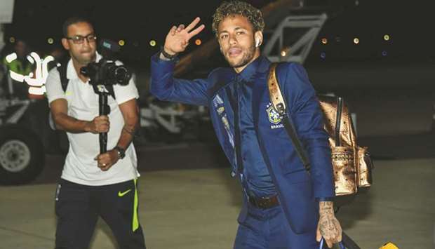 Brazilu2019s forward Neymar gestures upon the teamu2019s arrival at Sochi airport in Russia yesterday.