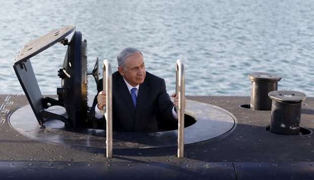 Israeli Prime Minister Benjamin Netanyahu climbs out after a visit inside the Rahav, the fifth submarine in the Israeli Navy's fleet, after it arrived in Haifa port January 12, 2016