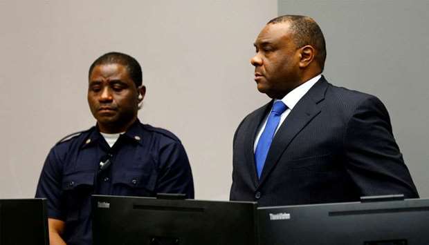 Jean-Pierre Bemba Gombo (R) of the Democratic Republic of the Congo stands in the courtroom of the International Criminal Court (ICC) in The Hague, June 21, 2016