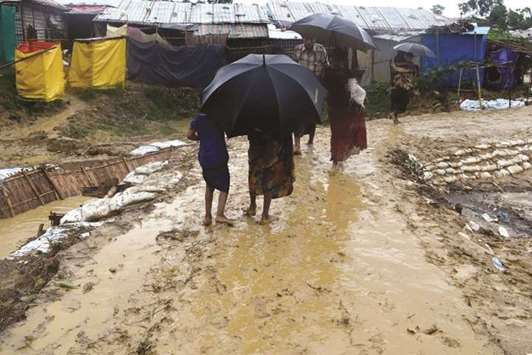 People walk after a storm at Balukhali refugee camp in Coxu2019s Bazar, Bangladesh, yesterday, in this image obtained from social media.