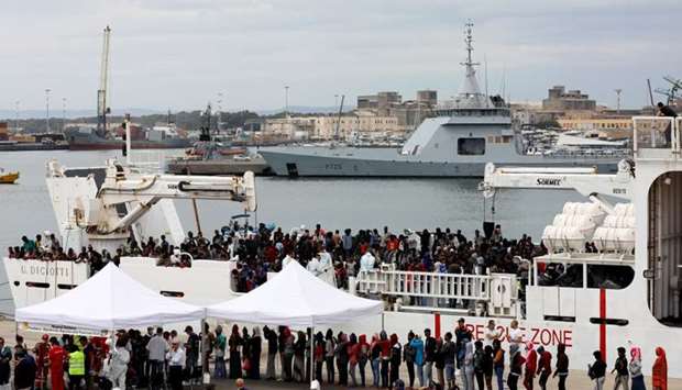 Migrants disembark Italian coast guard vessel ,Diciotti, as they arrive at the port of Catania, Italy.
