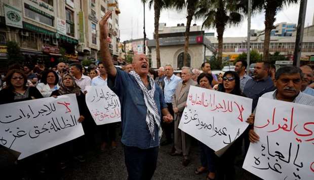 Palestinians take part in a protest demanding to lift the sanctions on Gaza Strip, in Ramallah, in the occupied West Bank.