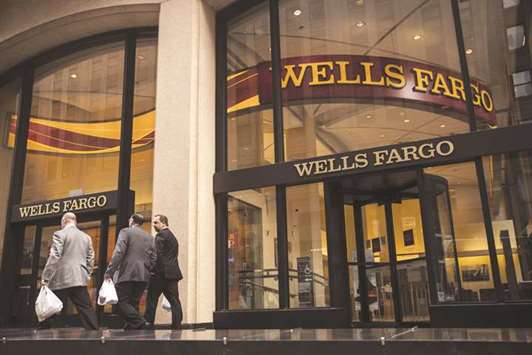 Pedestrians pass in front of a Wells Fargo & Co bank branch in New York. Wells Fargo and BlackRock see ESG as a growth engine for retirement assets even as the US Labour Department has urged retirement plan sponsors to use caution in this area.