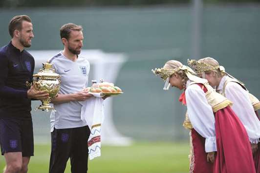 England coach Gareth Southgate (second from left) and striker Harry Kane (left) get welcome gifts before a training session in Zelenogorsk yesterday.