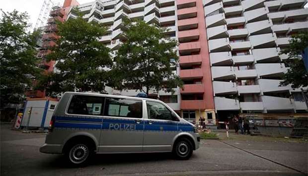 A police car stands in front of an apartment building in Cologne on Thursday after a Tunisian suspected of trying to build a biological weapon was arrested two days before.