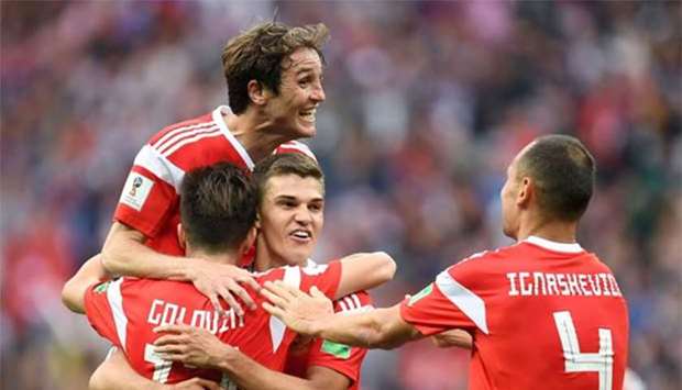 Russia's midfielder Aleksandr Golovin (left bottom) celebrates scoring his side's fifth goal with teammates in a World Cup Group A match against Saudi Arabia at the Luzhniki Stadium in Moscow on Thursday.