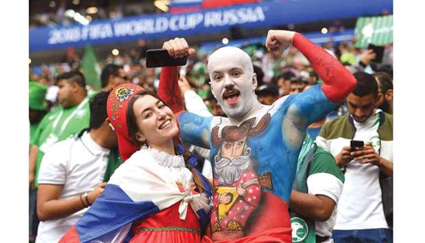 Russian fans pose as they wait for the start of the Russia 2018 World Cup Group A match against Saudi Arabia at the Luzhniki Stadium in Moscow yesterday.