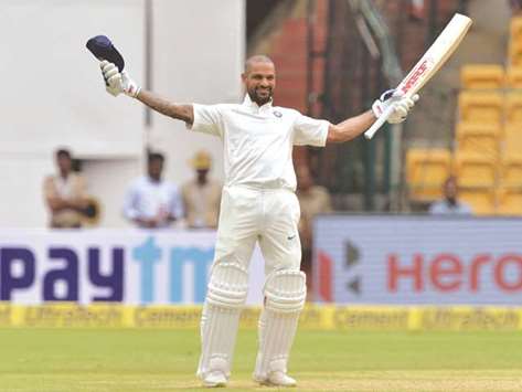 Indiau2019s batsman Shikhar Dhawan celebrates his century during the first day of the one-off Test against Afghanistan at The M Chinnaswamy Stadium in Bengaluru yesterday. (AFP)